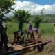 Babinsa Koramil Padang Batung, Kodim 1003 HSS bekerjasama dengan masyarakat membuat jembatan di area persawahan.