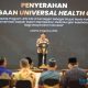 Direktur Utama BPJS Kesehatan Ali Ghufron Mukti saat menyampaikan laporan pada acara UHC Award 2024.