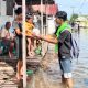 Anggota Mapala Uniska Banjarmasin memberikan bingkisan kepada anak-anak terdampak musibah banjir. (Foto : Mapala Uniska)